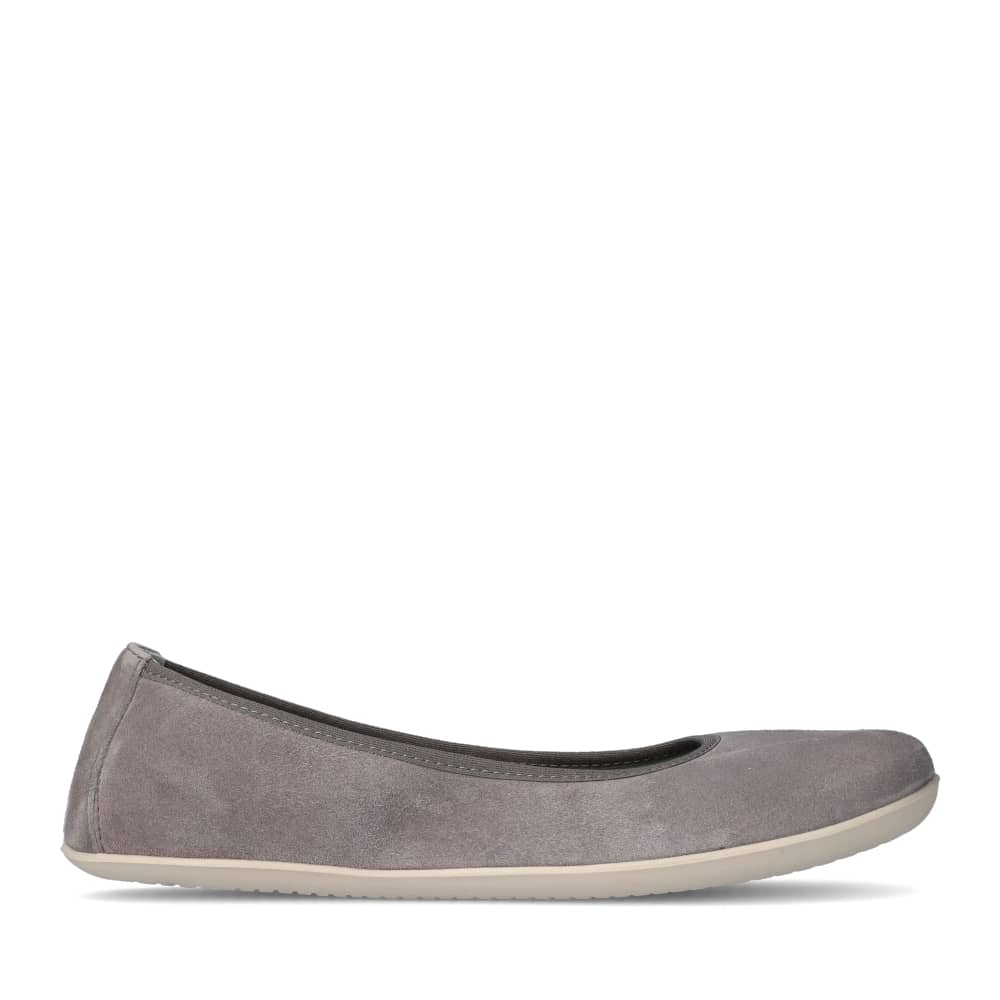 A photo of Groundies Lily Soft flats with a leather upper and cream rubber true sense soles. The flats are a nubuck in a grey color, the trim around the tops of the flats is also grey and is darker in color than the rest of the flats. The left flat is shown from the right side against a white background. #color_grey