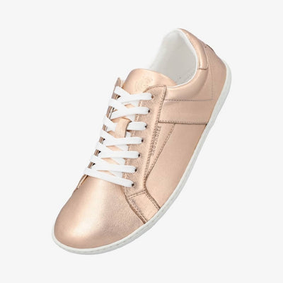 A photo of groundies melbourne shoe in metallic rose gold. Shoe is shown floating diagonally from the right side against a white background. #color_metallic-rose