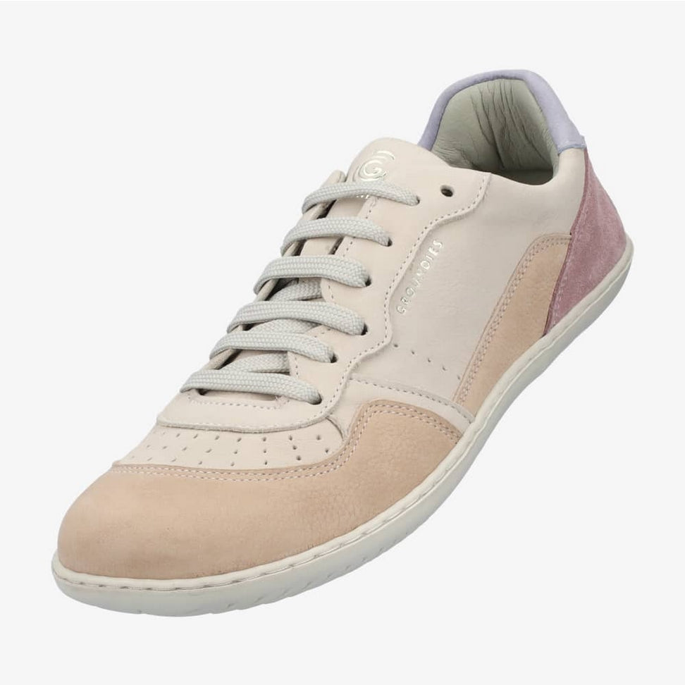 A photo of Groundies Nova GO1 Sneakers made with soft leather and white rubber soles. The sneakers have Beige, Periwinkle, and Pink color blocks. The left shoe is shown diagonally floating from the left against a white background in this photo. #color_beige-lavender-pink