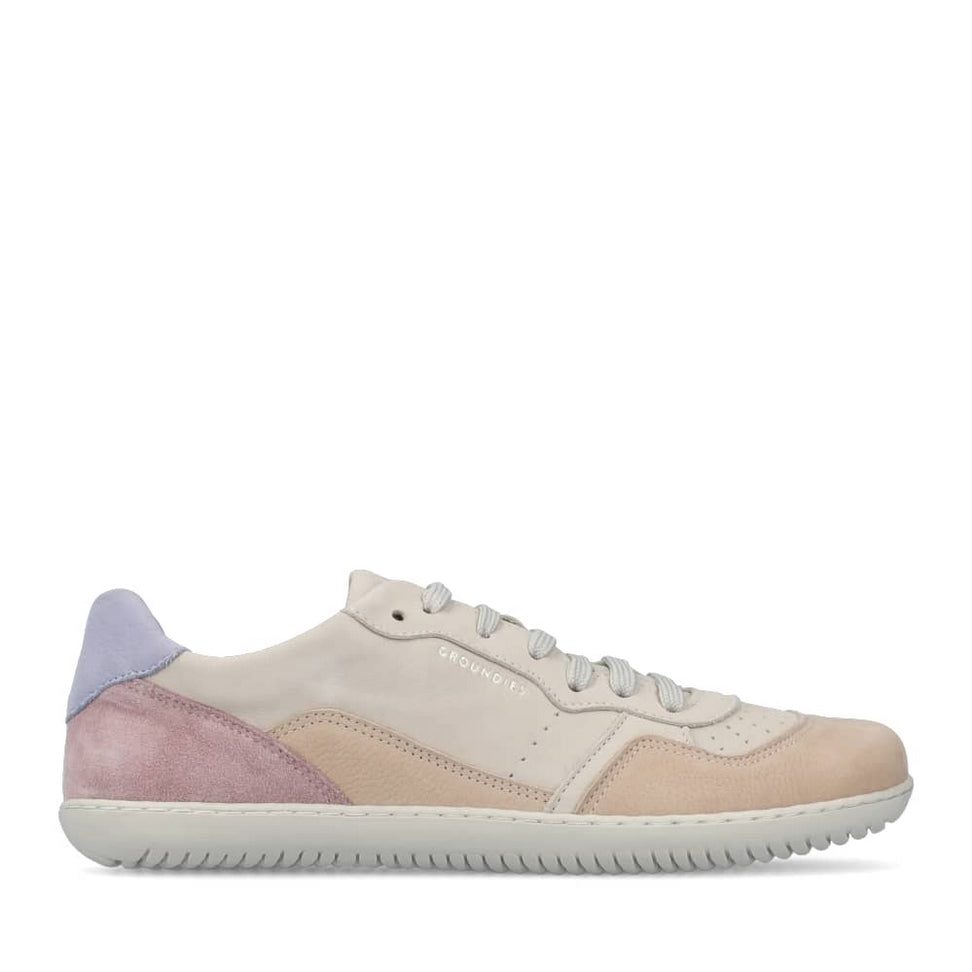 A photo of Groundies Nova GO1 Sneakers made with soft leather and white rubber soles. The sneakers have Beige, Periwinkle, and Pink color blocks. Right shoe is shown on the right side against a white background in this photo. #color_beige-lavender-pink