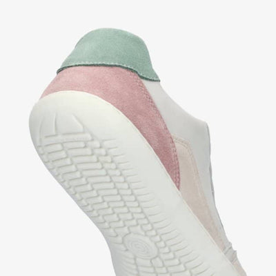 A photo of Groundies Nova GO1 Sneakers made with soft leather and white rubber soles. The sneakers have Beige, Green, and Pink color blocks. The left shoe is shown on the back side and below against a white background with a focus on the bumpy sole. #color_beige-green-pink