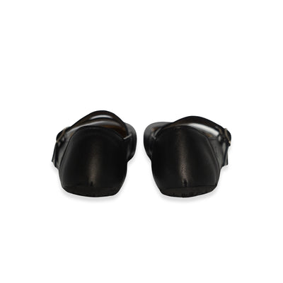 Black leather Villet Mary Jane flats with double straps with silver buckle closures, tan leather lining, and black rubber soles. Both shoes are shown from the back against a white background. #color_black-smooth