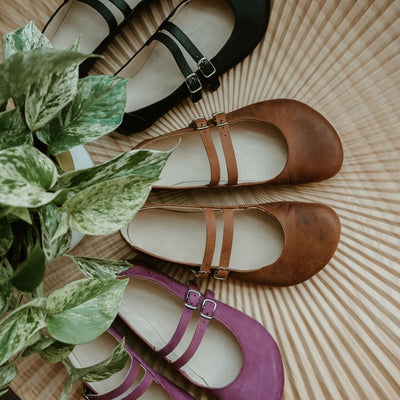 Mauve leather Villet Mary Jane flats with double straps with silver buckle closures, tan leather lining, and black rubber soles. #color_mauve-nubuck