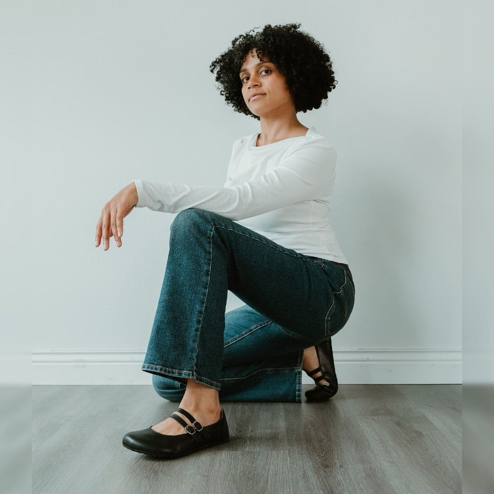Black leather Villet Mary Jane flats with double straps with silver buckle closures, tan leather lining, and black rubber soles. #color_black-smooth