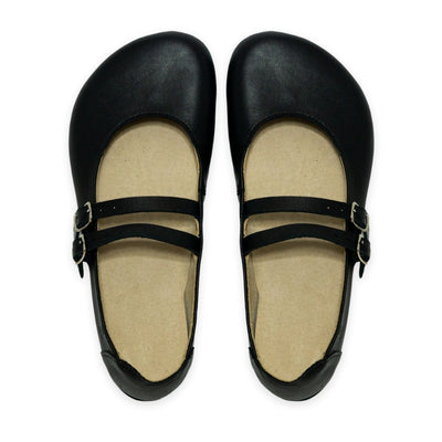 Black leather Villet Mary Jane flats with double straps with silver buckle closures, tan leather lining, and black rubber soles. Both shoes are shown from above against a white background. #color_black-smooth