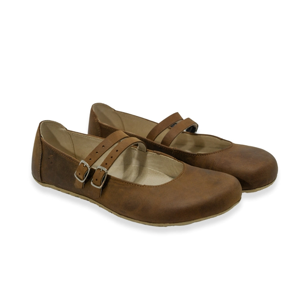 Brown nubuck leather Villet Mary Jane flats with double straps with silver buckle closures, tan leather lining, and tan rubber soles. Both shoes are shown facing diagonally right against a white background. #color_brown-nubuck