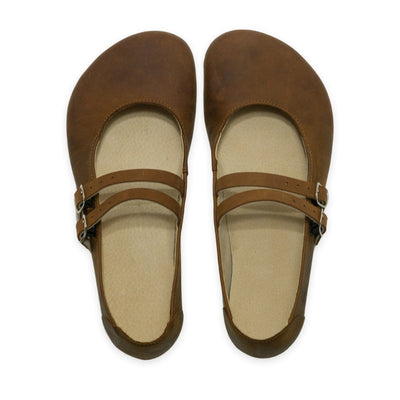 Brown nubuck leather Villet Mary Jane flats with double straps with silver buckle closures, tan leather lining, and tan rubber soles. Both shoes are shown from above against a white background. #color_brown-nubuck