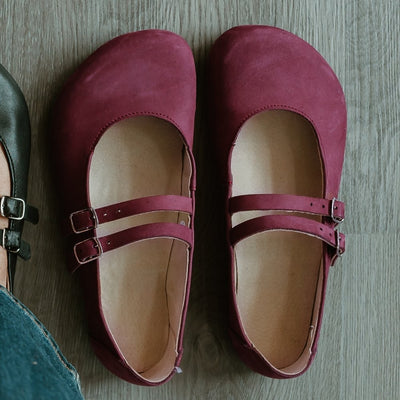 Mauve leather Villet Mary Jane flats with double straps with silver buckle closures, tan leather lining, and black rubber soles. #color_mauve-nubuck