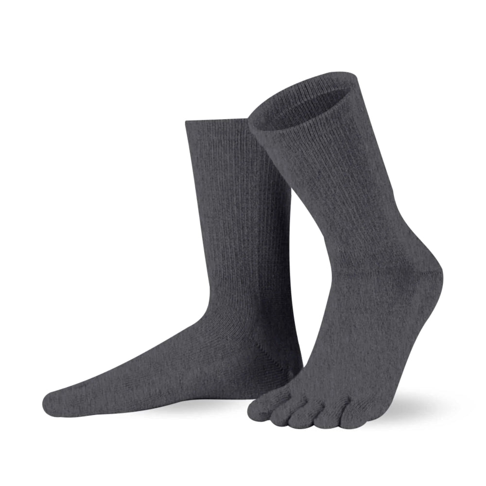 A pair of charcoal Knitido crew-cut cotton & merino toe socks. Both socks are shown facing diagonally left against a white background with the left heel up. #color_charcoal