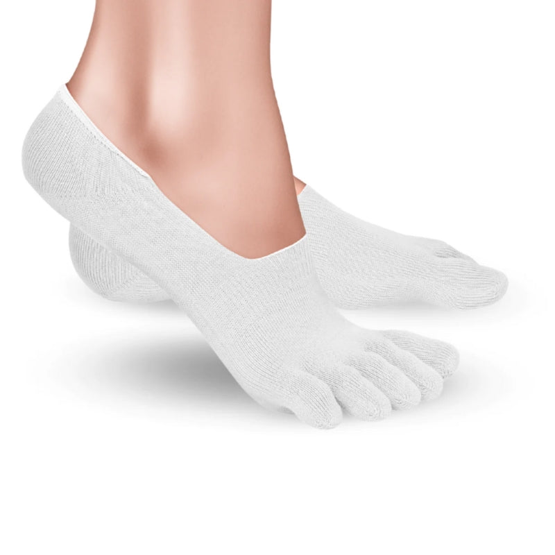 A photo of Knitido low cut toe socks made with cotton, nylon, polyester, and elastane. The socks are a white color. A woman is shown from ankle down wearing the low cut socks, she is facing to the right with right foot’s heel lifted slightly off the floor against a white background. #color_white
