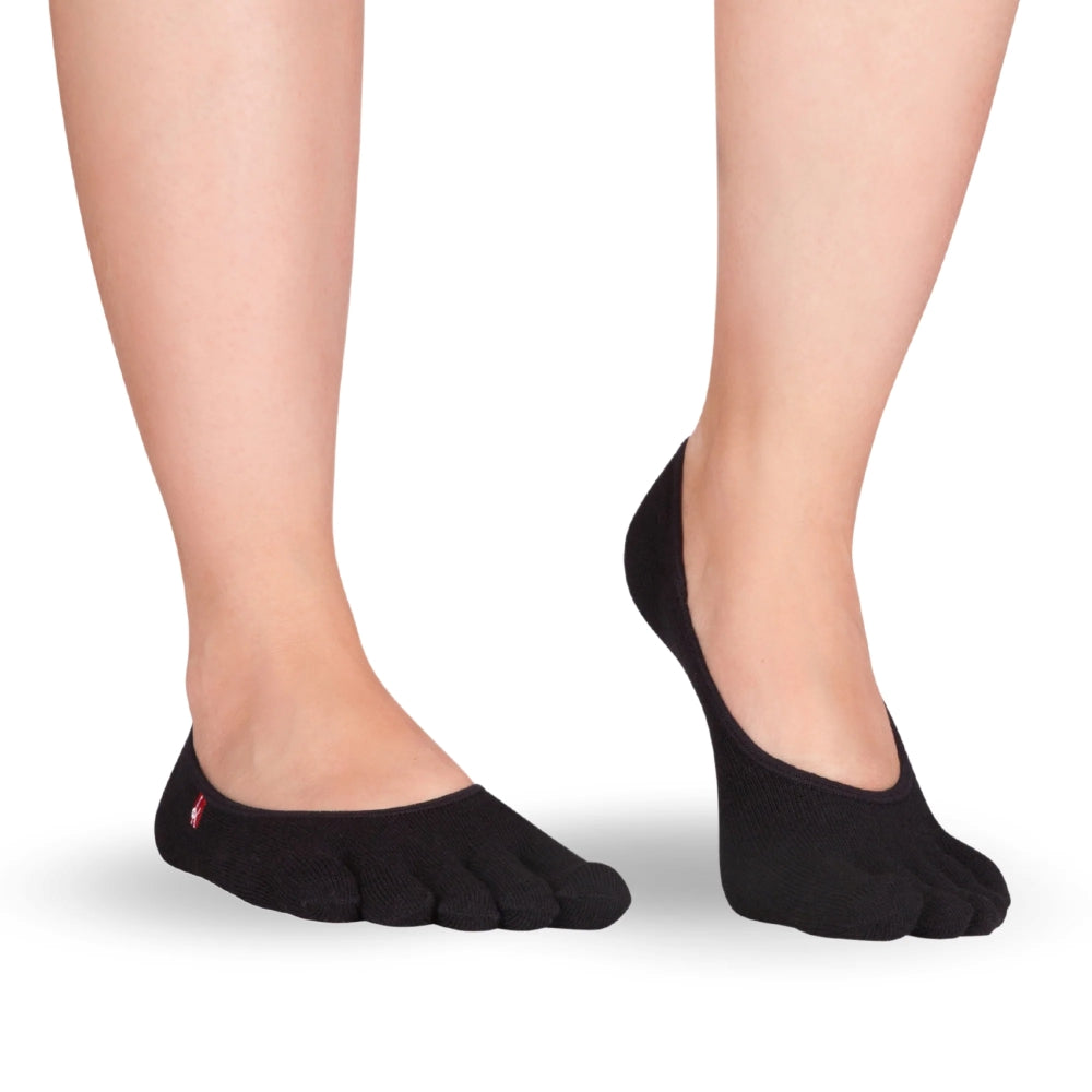 A pair of black Knitido track and trail zero toe socks. Socks are very low cut to be invisible in shoes. Both socks are shown facing diagonally right against a white background on a person with the right heel up. #color_black