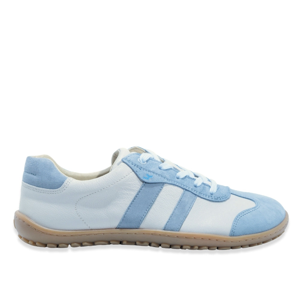 White Koel Ila sneakers with two diagonal, baby blue stripes on either side and color block at the top of the heel with natural rubber colored soles. A baby blue leather T-shape design is present at the top of the toe box with the same color edging the light blue laces. Right shoe is shown facing right against a white background. #color_aqua