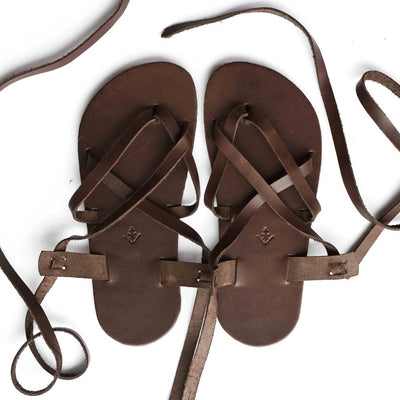 A brown leather strappy sandal shown from above on a white background. #color_brown