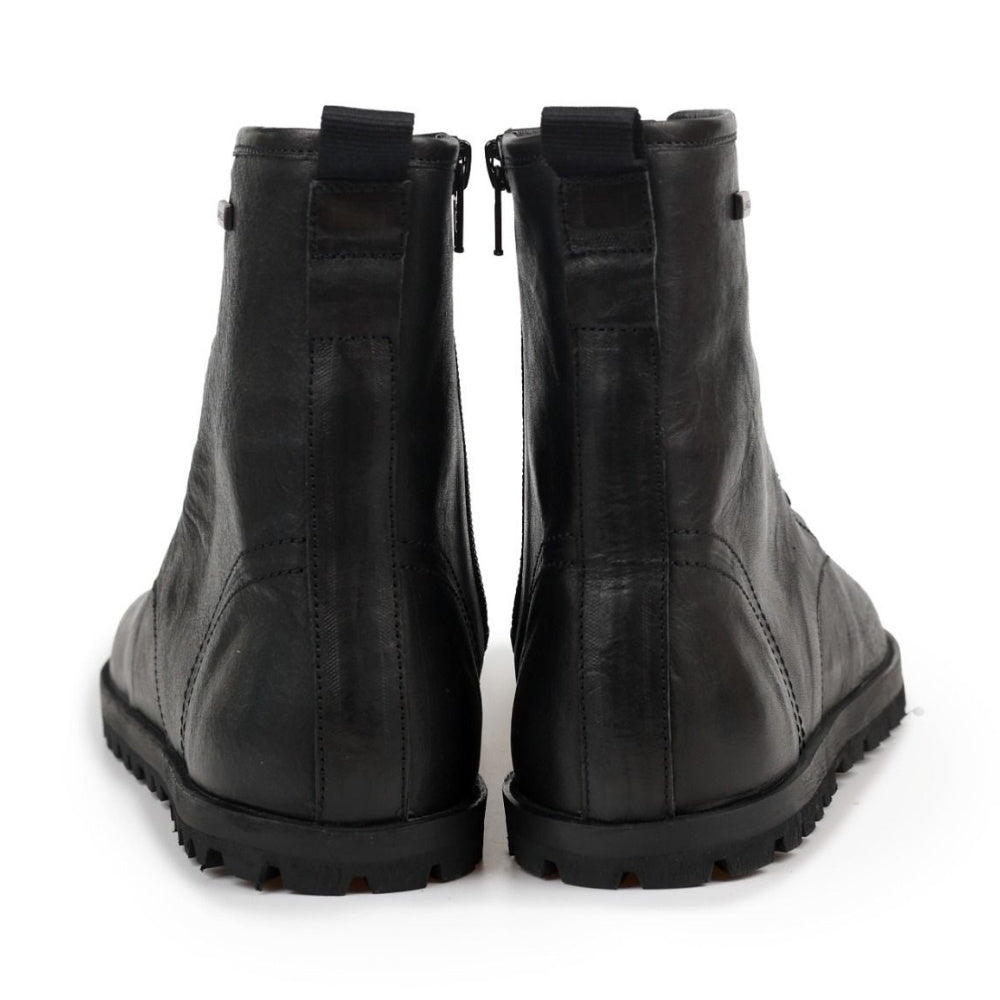 Black, smooth leather Lang.S Kombat boot, with round black laces, a pull tab, zipper, and chinky black soles. Both shoes are shown from the back against a white background. #color_black