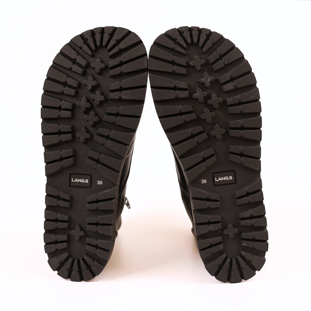 Black, smooth leather Lang.S Kombat boot, with round black laces, a pull tab, zipper, and chinky black soles. Both shoes are shown facing up showing the soles against a white background. #color_black