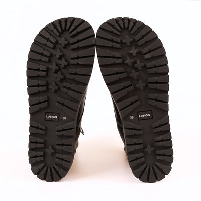 Black, smooth leather Lang.S Kombat boot, with round black laces, a pull tab, zipper, and chinky black soles. Both shoes are shown facing up showing the soles against a white background. #color_black