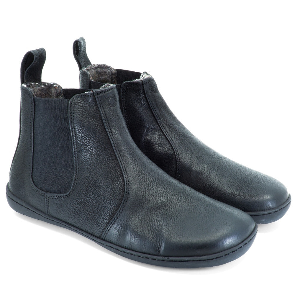 All black Mukishoes felted-wool-lined, leather Chelsea boots with elastic panels on both sides, a pull tab at the back/top of the opening, and a stitched, rubber sole. Both boots are shown facing diagonally right against a white background. #color_black