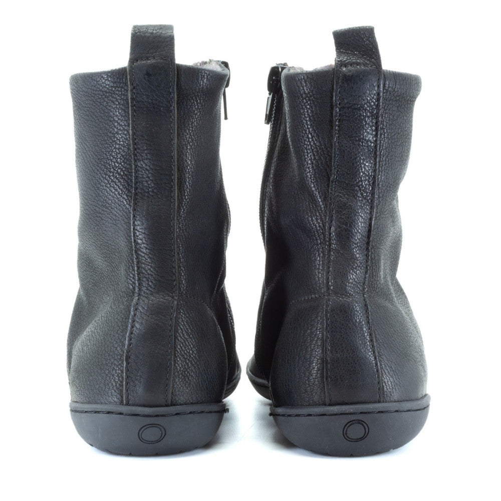 Black, leather, wool-lined Mukishoes Igneous combat-style, zip-up boots. Both shoes are shown from the back against a white background. #color_black