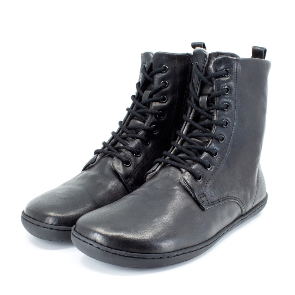 Black, leather, wool-lined Mukishoes Igneous combat-style, zip-up boots. Both shoes are shown here facing diagonally left against a white background. #color_black