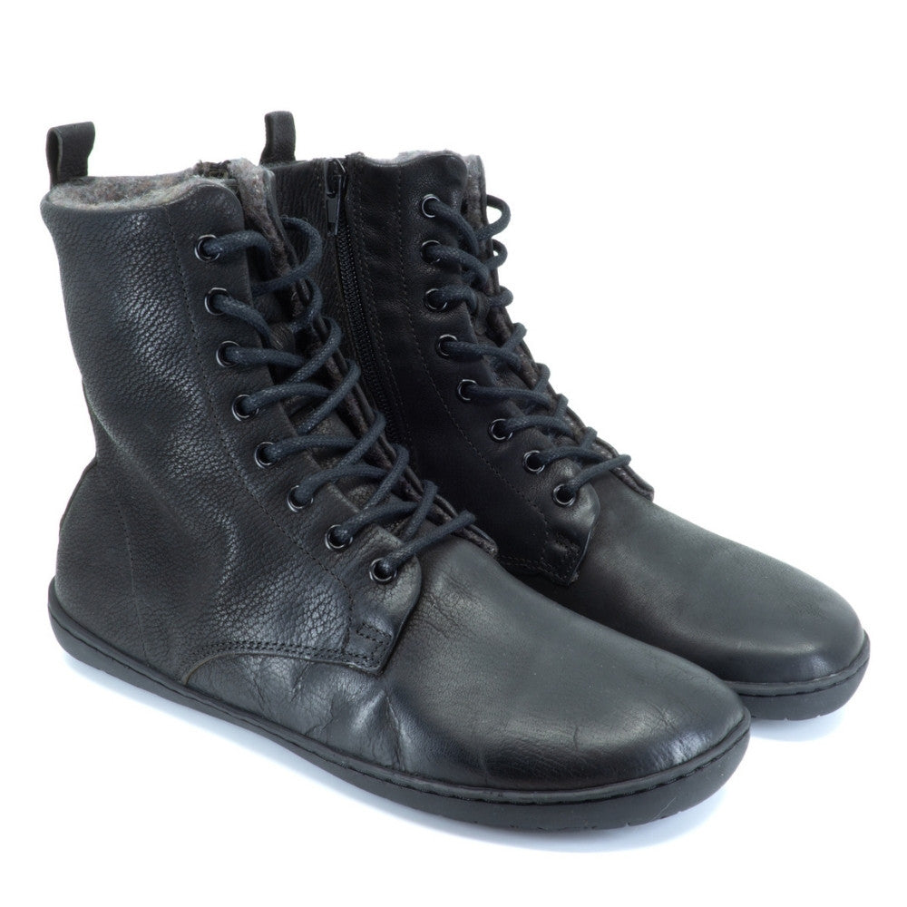 Black, leather, wool-lined Mukishoes Igneous combat-style, zip-up boots. Both shoes are shown facing diagonally right against a white background. #color_black