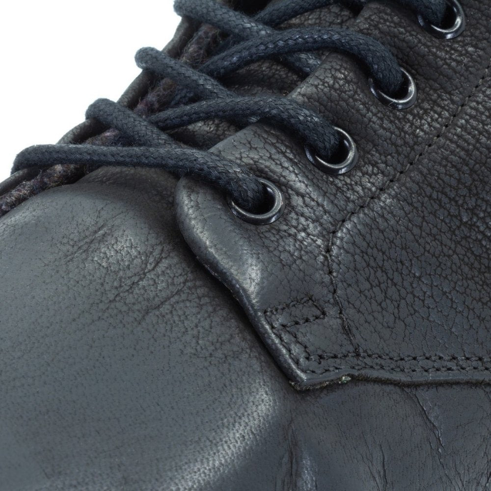 Black, leather, wool-lined Mukishoes Igneous combat-style, zip-up boots. Right shoe laces are shown close up here against a white background. #color_black