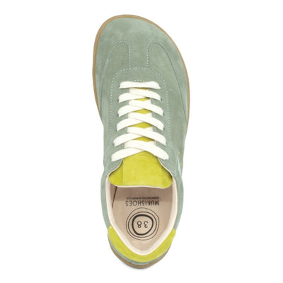 Theia (multiple green colors) Mukishoes Lyra suede leather sneakers with, white laces, and a natural rubber colored sole. Shoes are all sage green colored with a T-shaped detail on the toe box in sage green, a T-shaped seafoam green detail on both sides of the ankle, and neon green color detail on the top of the tongue and heel. Right shoe is shown from above against a white background. #color_theia