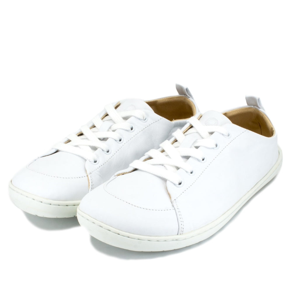 A photo of white Mukishoes Raw Leather Cloud sneakers. Shoes are simple in design, have a pull tab on the back, and tan leather lining. Both shoes are shown diagonally here facing slightly to the left against a white background. #color_raw-leather-cloud