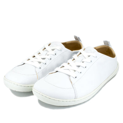 A photo of white Mukishoes Raw Leather Cloud sneakers. Shoes are simple in design, have a pull tab on the back, and tan leather lining. Both shoes are shown diagonally here facing slightly to the left against a white background. #color_raw-leather-cloud