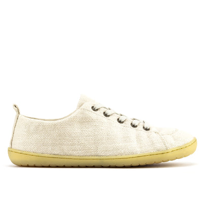 A photo of Mukishoes Sand fabric sneakers. Shoes are simple in design with a subtle herringbone pattern, brass-colored rivets, a pull tab on the back, and sand-colored lining, laces, and gum-colored soles. Right shoe is shown here facing to the right against a white background. #color_sand