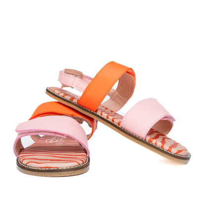 Orange and Pink So Wild PaperKrane leather sandals. Front strap over the ball of the foot and heel straps are pink and thinner strap over the arch is a reddish orange. Sole is an orange and red zebra print. Right shoes is shown from the front with the right shoe heel resting on it facing right against a white background. #color_orange-pink