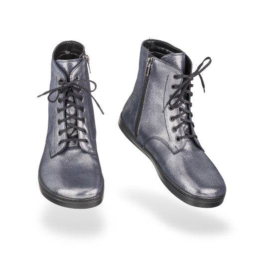 Dark silver leather Peerko Go combat boots made with fleece lining, a black zipper, black laces, and black rubber soles. Both boots are shown floating forward angled slightly to the right against a white background. #color_cosmic-silver