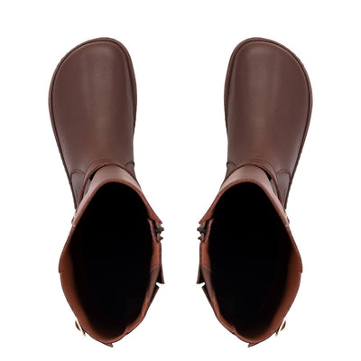 A photo of Shapen Glam lined riding boots made with leather, a faux fur lining, and brown rubber soles. The boots are brown in color with gold buckles on the top and around the ankle, the ankle buckle strap is removable. Both boots are shown from above against a white background. #color_brown