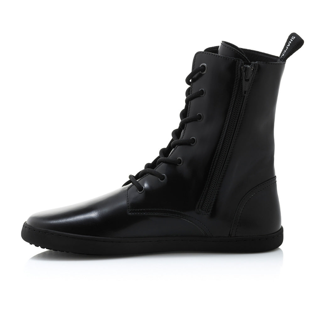 Black leather Shapen Maverick combat boots with a black, branded pull tab, a side zipper, black laces, and black rubber soles. Right shoe is shown facing left against a white background. #color_black