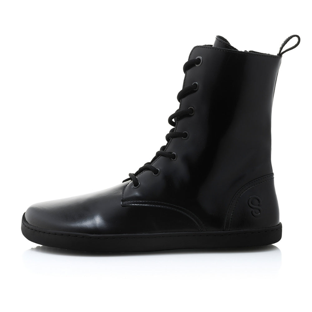 Black leather Shapen Maverick combat boots with a black, branded pull tab, a side zipper, black laces, and black rubber soles. Left shoe is shown facing left against a white background. #color_black