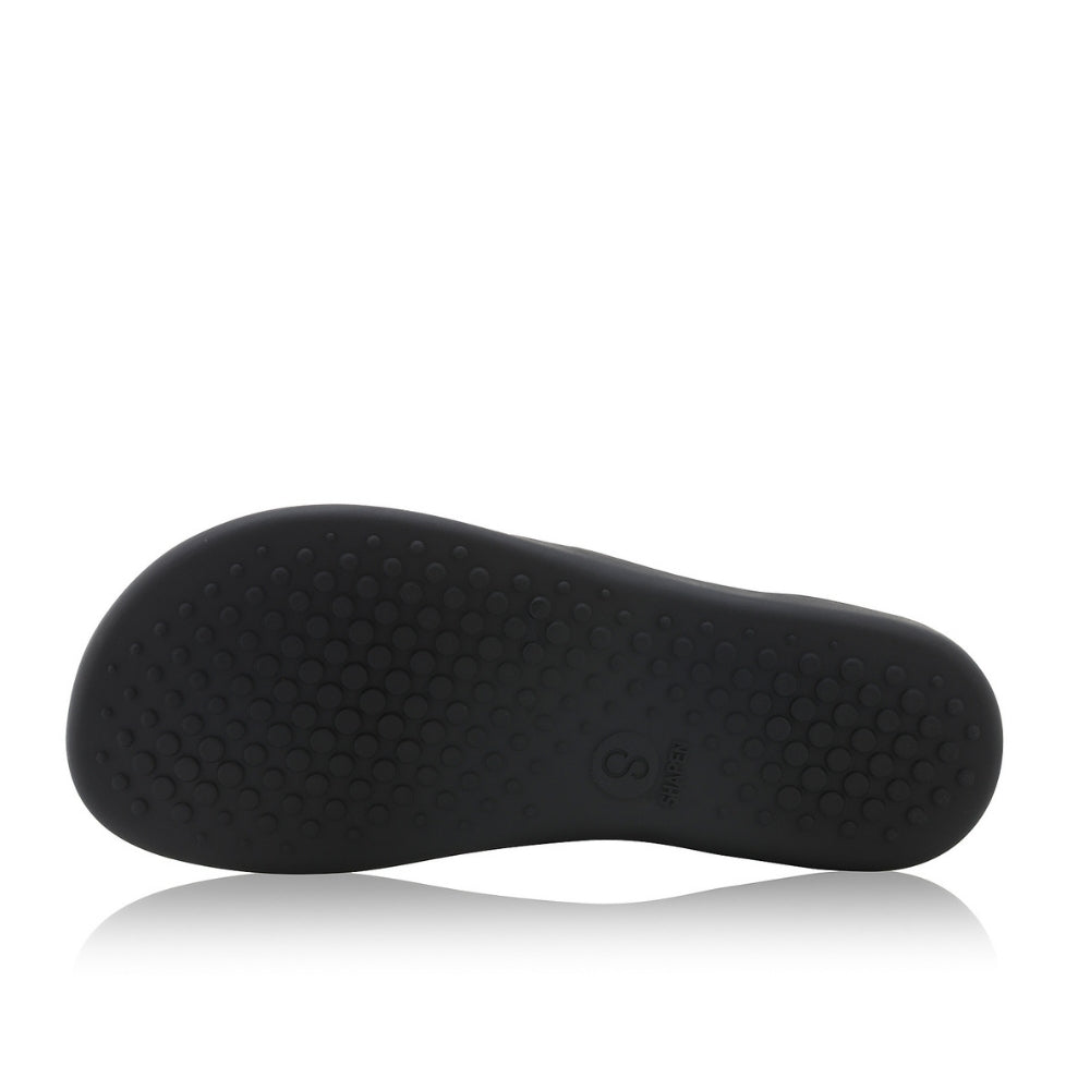 Black leather Shapen Maverick combat boots with a black, branded pull tab, a side zipper, black laces, and black rubber soles. Left shoe sole is shown facing left against a white background. #color_black