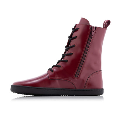 Dark red leather Shapen Maverick combat boots with a red, branded pull tab, a side zipper, black laces, and black rubber soles. Right shoe is shown facing left against a white background. #color_bordeaux