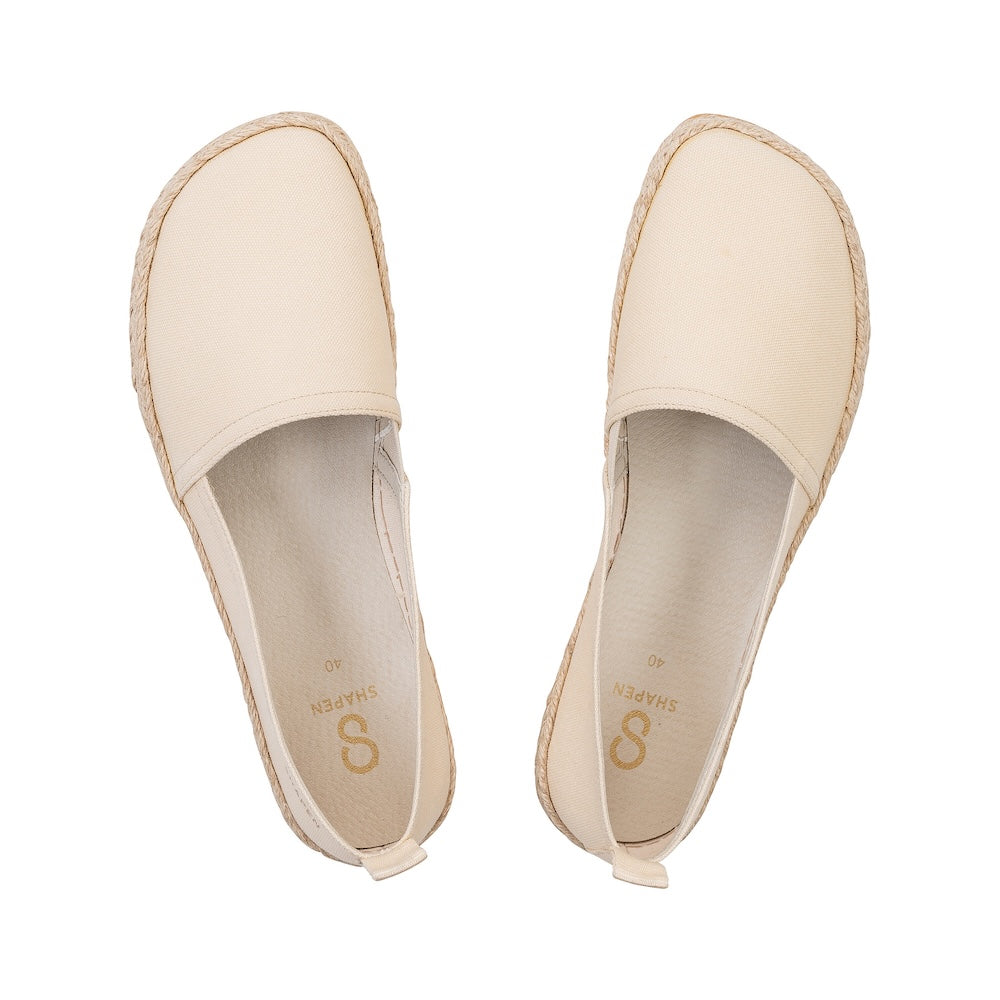 Beige canvas Shapen Espadrilles loafers with a pull tab and tan soles. Both shoes are shown from above against a white background. #color_beige