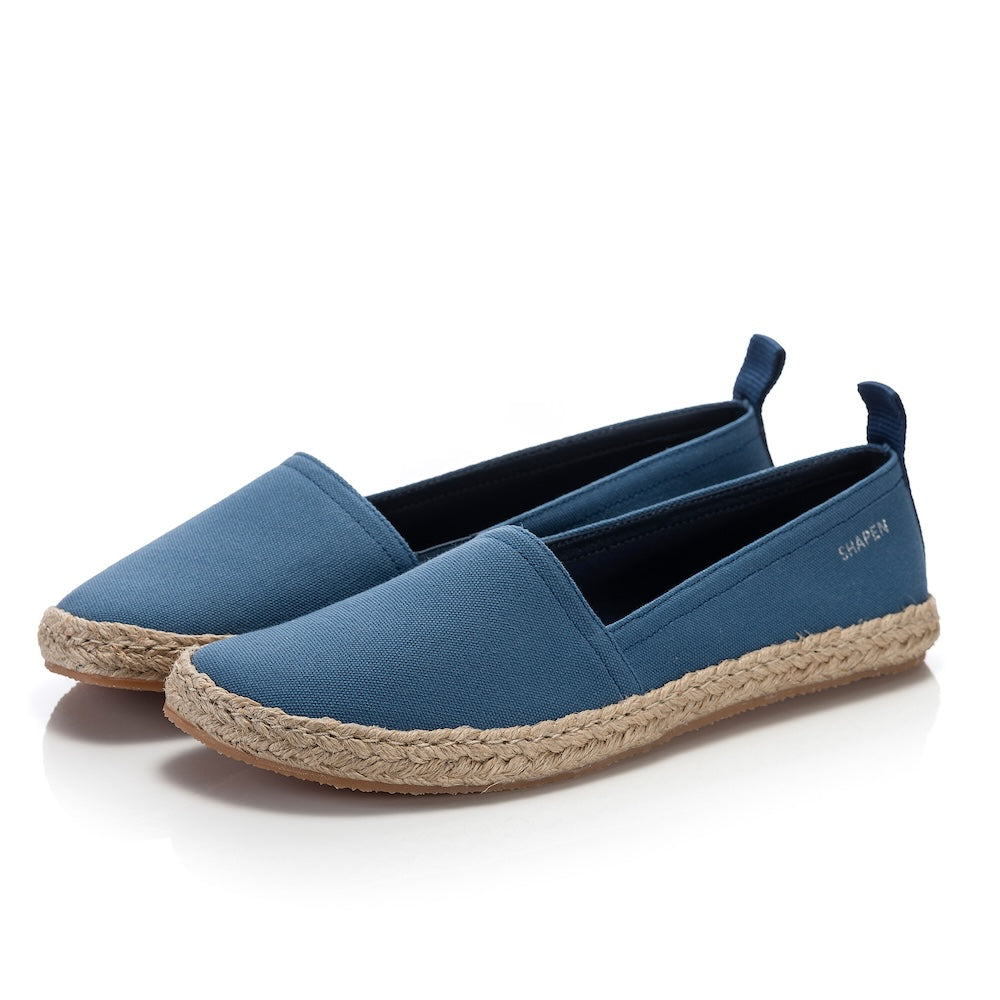 Indigo canvas Shapen Espadrilles loafers with a pull tab and tan soles. Both shoes are shown facing diagonally left against a white background. #color_indigo