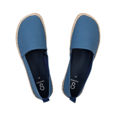 Indigo canvas Shapen Espadrilles loafers with a pull tab and tan soles. Both shoes are shown from above against a white background. #color_indigo