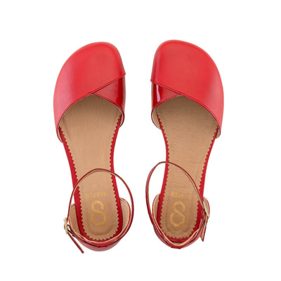 Red leather Shapen Poppy D’orsay dressy flats with a tan footbed and tan rubber soles. The flats have a heel cup held on by a dainty, patent leather ankle strap. Both flats are shown from above against a white background. #color_cherry