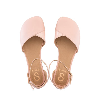 A photo of Shapen Poppy D’orsay dressy flats with a leather upper and rubber soles. The flats are a rose beige color with a heel cup and dainty ankle strap, the inside of the sole are a beige color. Both flats are shown from the top facing up against a white background. #color_rose