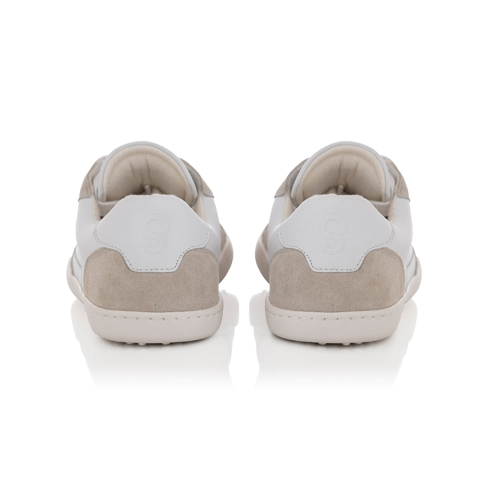 A photo of Shapen ReWind leather sneakers in white. Shoes are a classic chunky sneaker design with beige suede color blocks surrounding the toe guard, laces, and heels. Both shoes are shown here from the back against a white background. #color_white