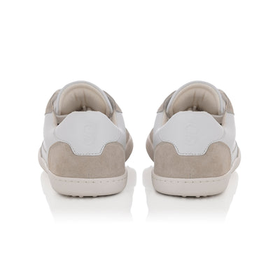 A photo of Shapen ReWind leather sneakers in white. Shoes are a classic chunky sneaker design with beige suede color blocks surrounding the toe guard, laces, and heels. Both shoes are shown here from the back against a white background. #color_white