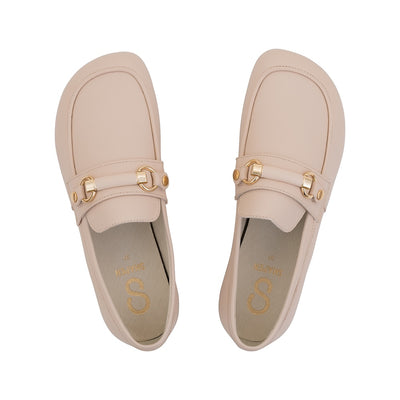Beige leather Shapen Versa loafers. Shoes are a classic loafer design with a leather decoration capped by gold metal rings across the foot and tan rubber soles glued on. Both shoes are shown from above against a white background. #color_beige