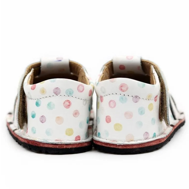 A photo of Tikki Aranya kids sandals in Confetti. Sandals are surrounded in leather with 4 slits on each side and a velcro closure across the foot. Footbed is brown and soles are black. Both shoes are shown here from the back against a white background. #color_confetti