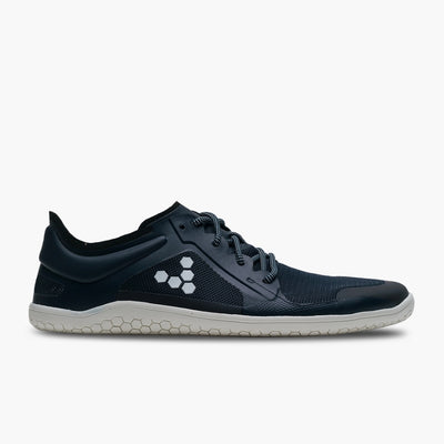 A photo of recycled plastic Navy Vivobarefoot Primus lite sneakers with white rubber soles and a white vivobarefoot logo on the side. Recycled mesh fabric surrounds the shoe with a thicker recycled guard around the sole, laces, and ankle opening. Right shoe is shown facing right against a white background. #color_navy