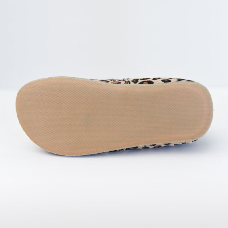A photo of Yasemin Leather loafers Designed by Anya with a leather upper and tan rubber soles. The leopard calf hair Yasemin is shown here for a photo of the beige rubber sole against a white background. #color_brown