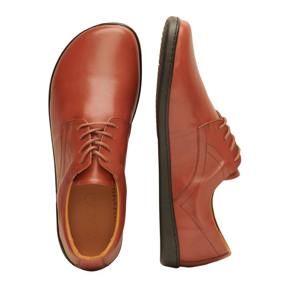 Cognac Zaqq Peaq leather dress shoes with coganc laces and black rubber soles. Left shoe is shown from above with the right shoe next to it leaning over against a white background. #color_cognac