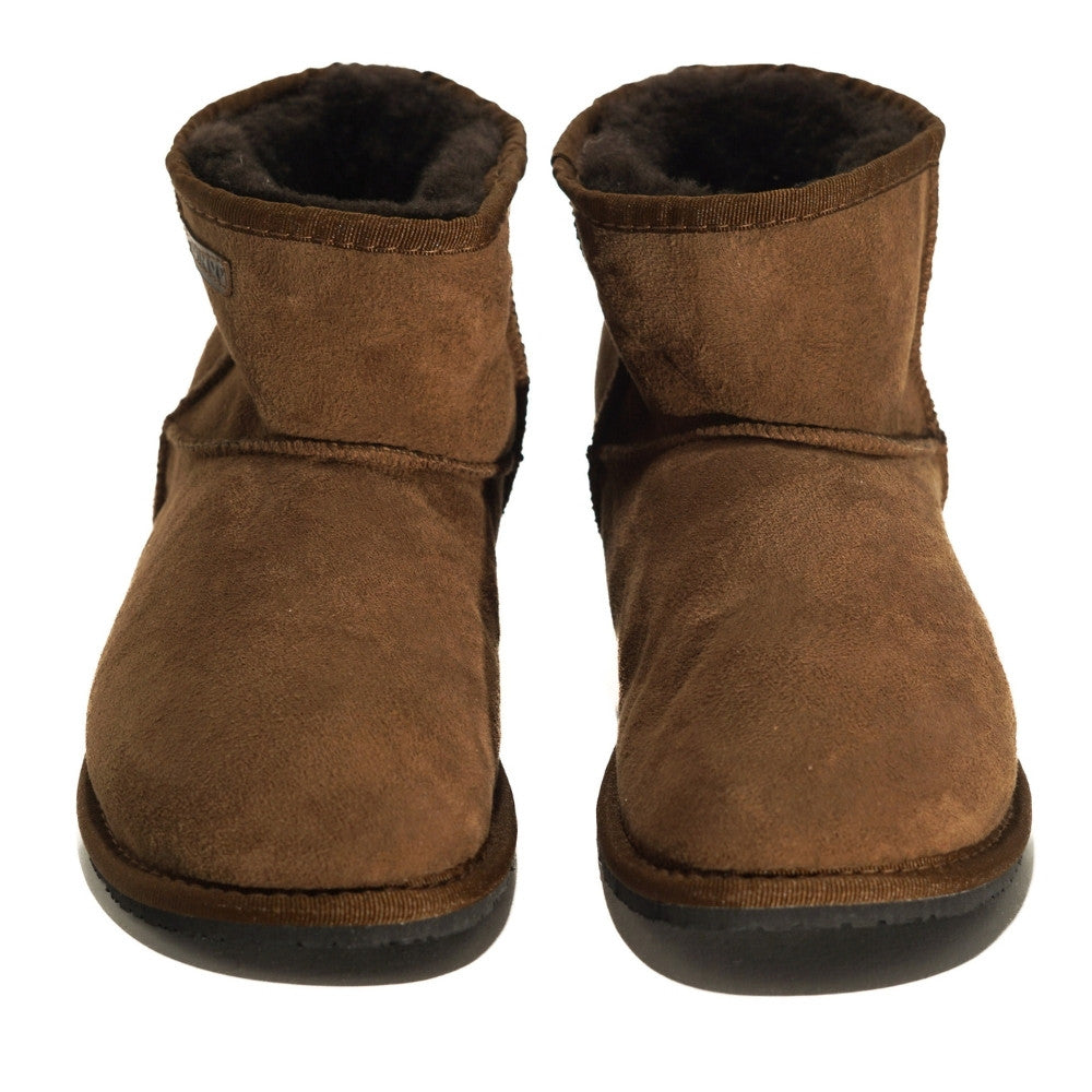 A plain brown Zeazoo Dingo Mini sheepskin ankle boot with a back pull tab, brown wool lining, and black rubber vibram soles. Both shoes are shown from the front against a white background. #color_brown