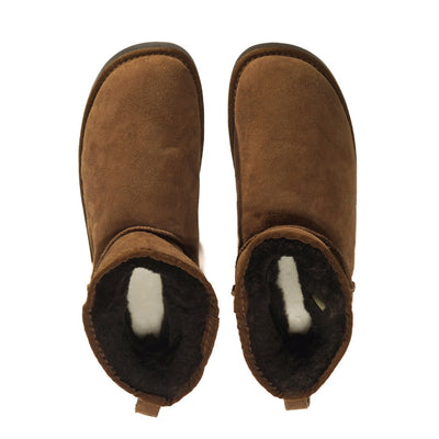 A plain brown Zeazoo Dingo Mini sheepskin ankle boot with a back pull tab, brown wool lining, and black rubber vibram soles. Both shoes are shown from above against a white background. #color_brown